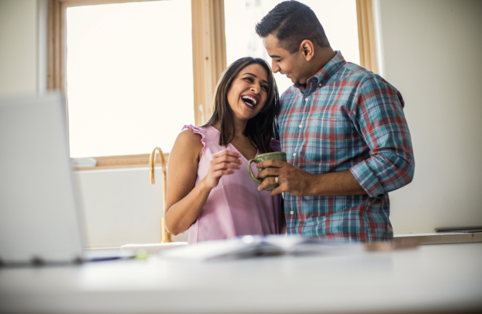 couple in kitchen enjoying coffee