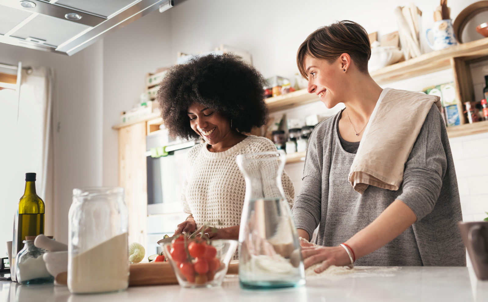 two women in kitchen preparing food