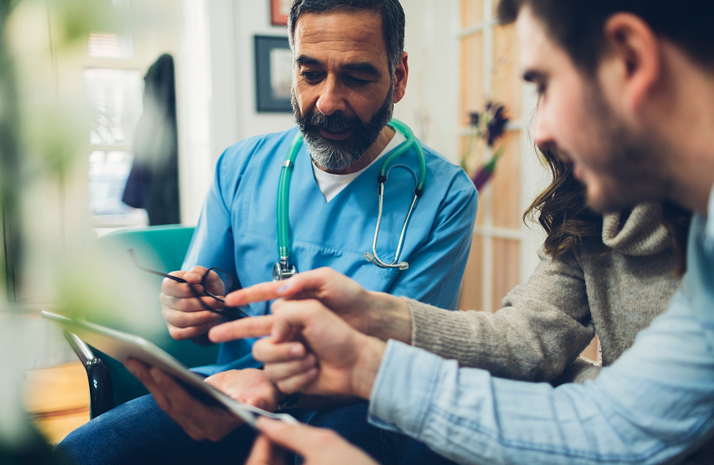 A healthcare professional talks with a couple about fertility treatments.