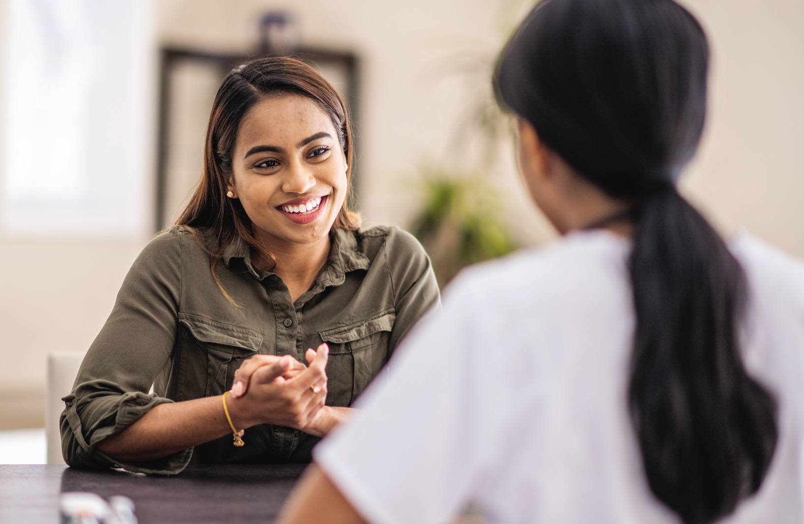 A female patient speaks with a healthcare provider.