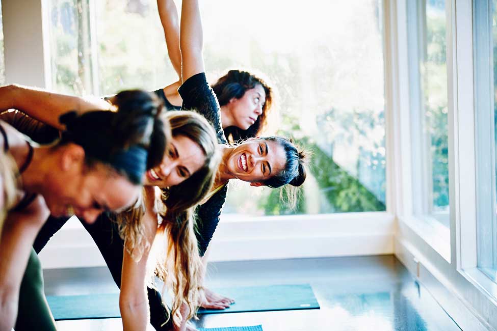 A group of women practicing yoga in a studio