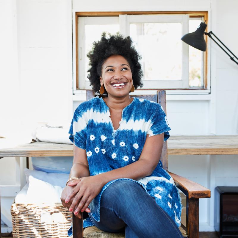 woman smiling on chair in home office